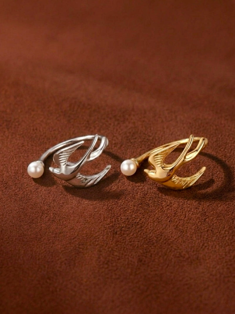 Ascending freshwater pearl bird cuff ring in gold and silver finishes, each featuring a sculpted bird motif wrapping around a luminous pearl.