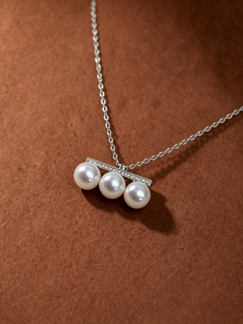 Axis Akoya Pearl Pave Bar Chain Necklace featuring three luminous 7mm Akoya white pearls suspended from a horizontal pave bar pendant on a delicate silver chain.