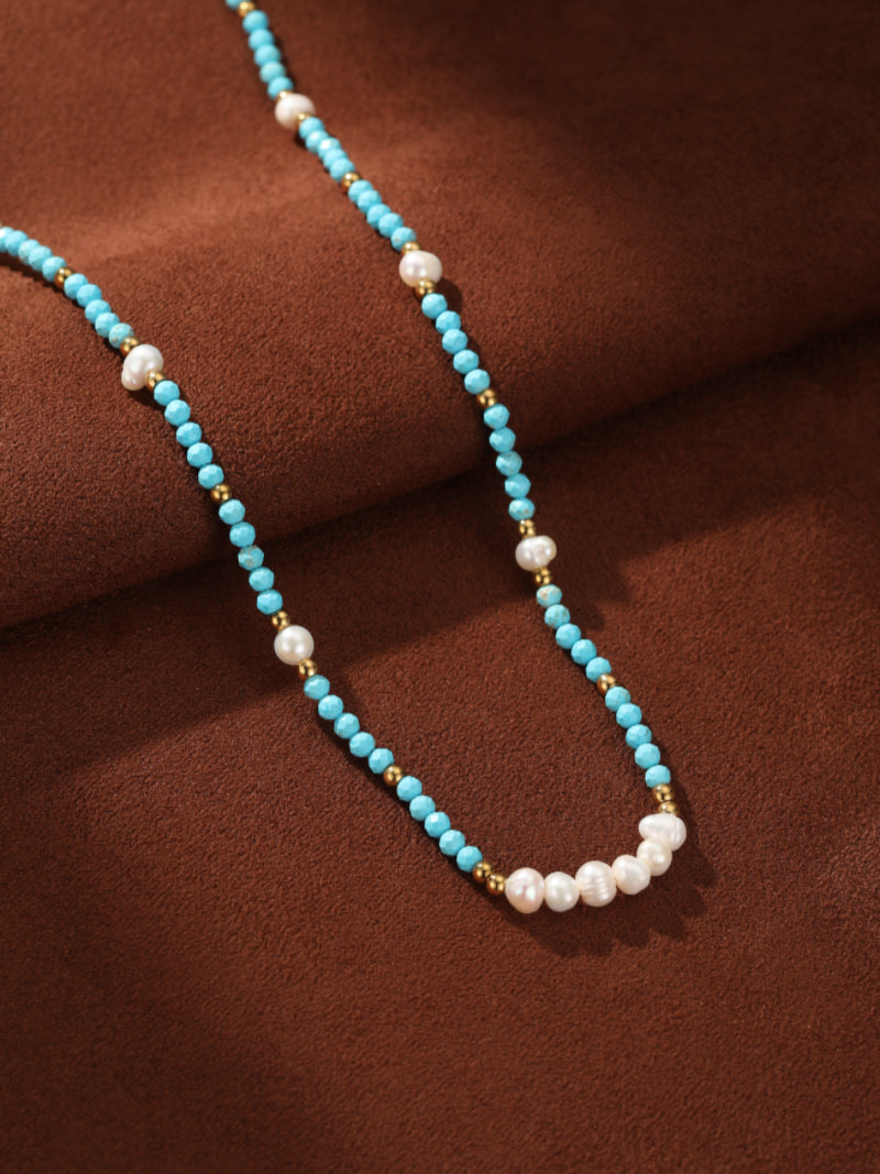 Azure Drift necklace featuring a delicate chain with turquoise-hued beads and luminous white freshwater pearls, accented with small gold beads.