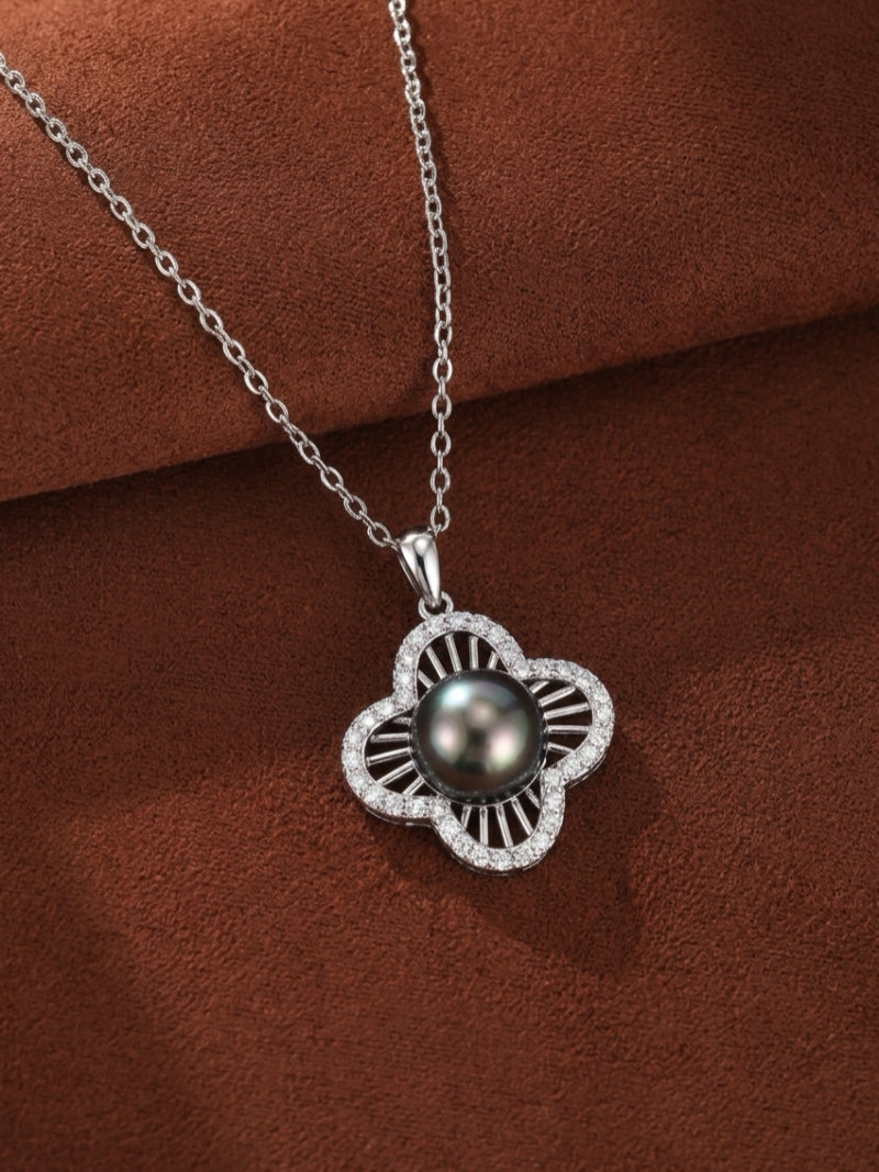 Chalice Tahitian Mabe Pearl Quatrefoil Single Pendant Necklace featuring a black Tahitian pearl surrounded by a diamond-encrusted quatrefoil motif on a silver chain.