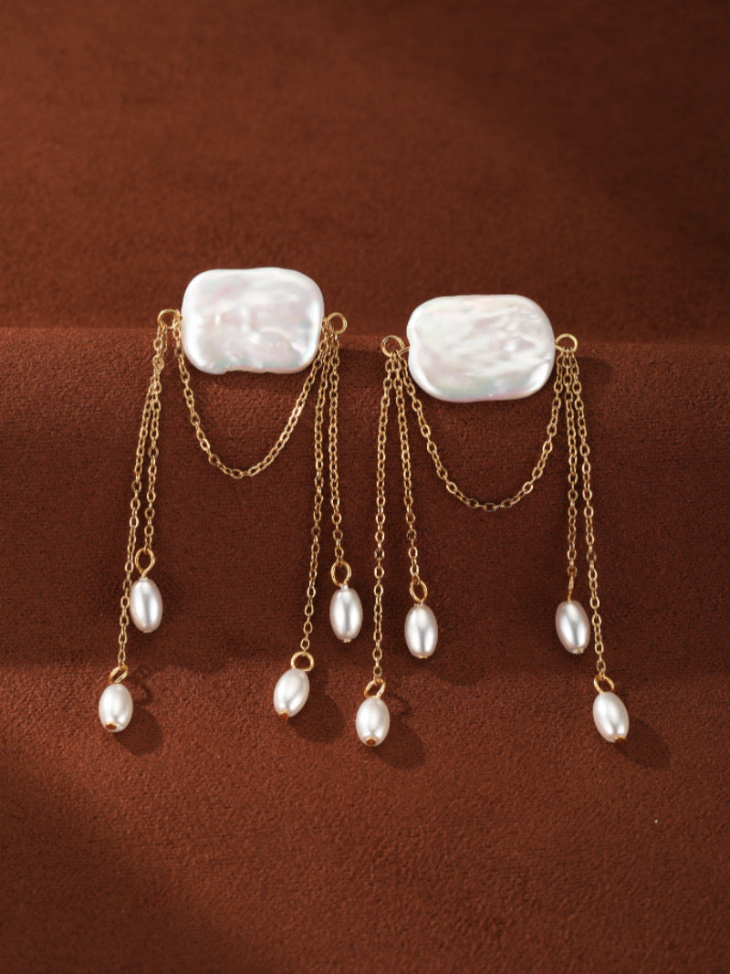 Driftfall Freshwater Pearl Fringe Drop Earrings featuring a large baroque pearl top with delicate gold chains cascading down, adorned with smaller white freshwater pearls.