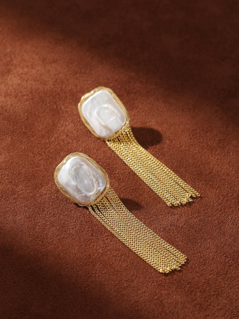 Epoch Fringe dangle earrings featuring large, irregular white freshwater baroque pearls set in gold-toned wire with cascading gold-toned chain fringe. @pearl