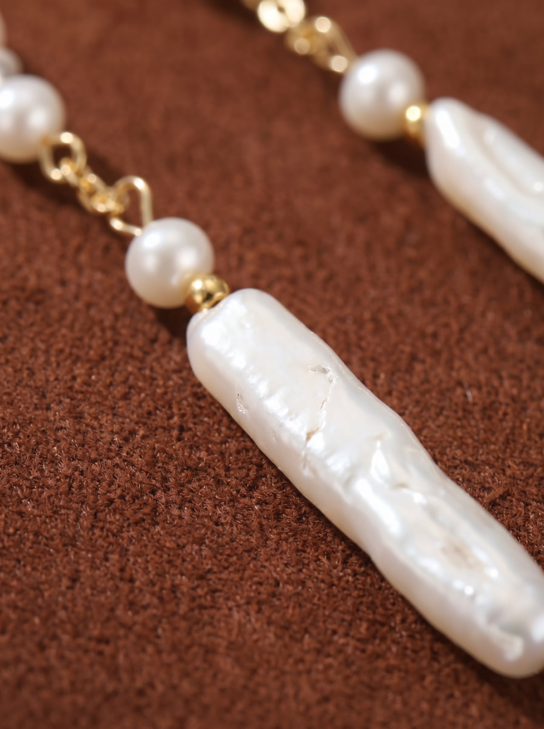 Flow - Freshwater Pearl Long Dangle Earrings with delicate seed pearls and elongated baroque pearls on a brown textured background @pearl