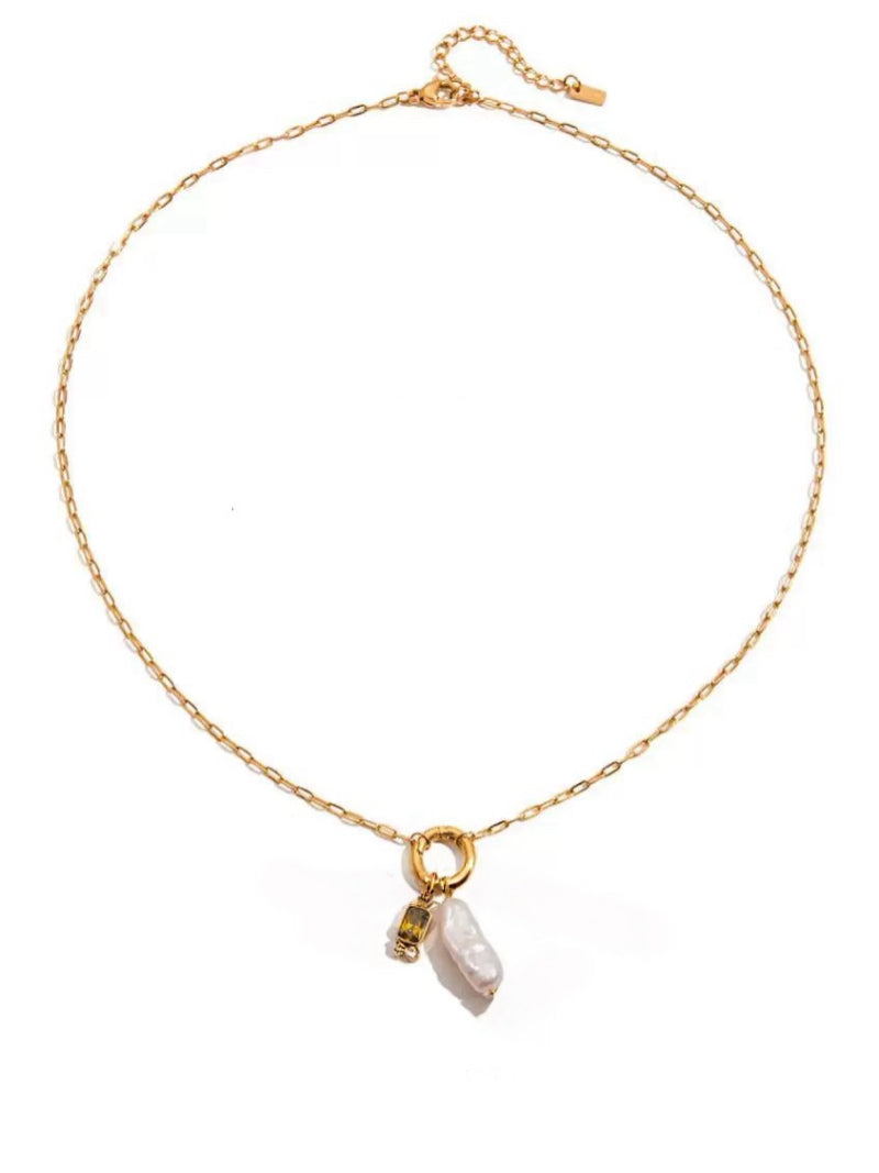 Gaiety gold-tone necklace featuring a baroque freshwater pearl and a green gemstone drop pendant on a delicate chain.