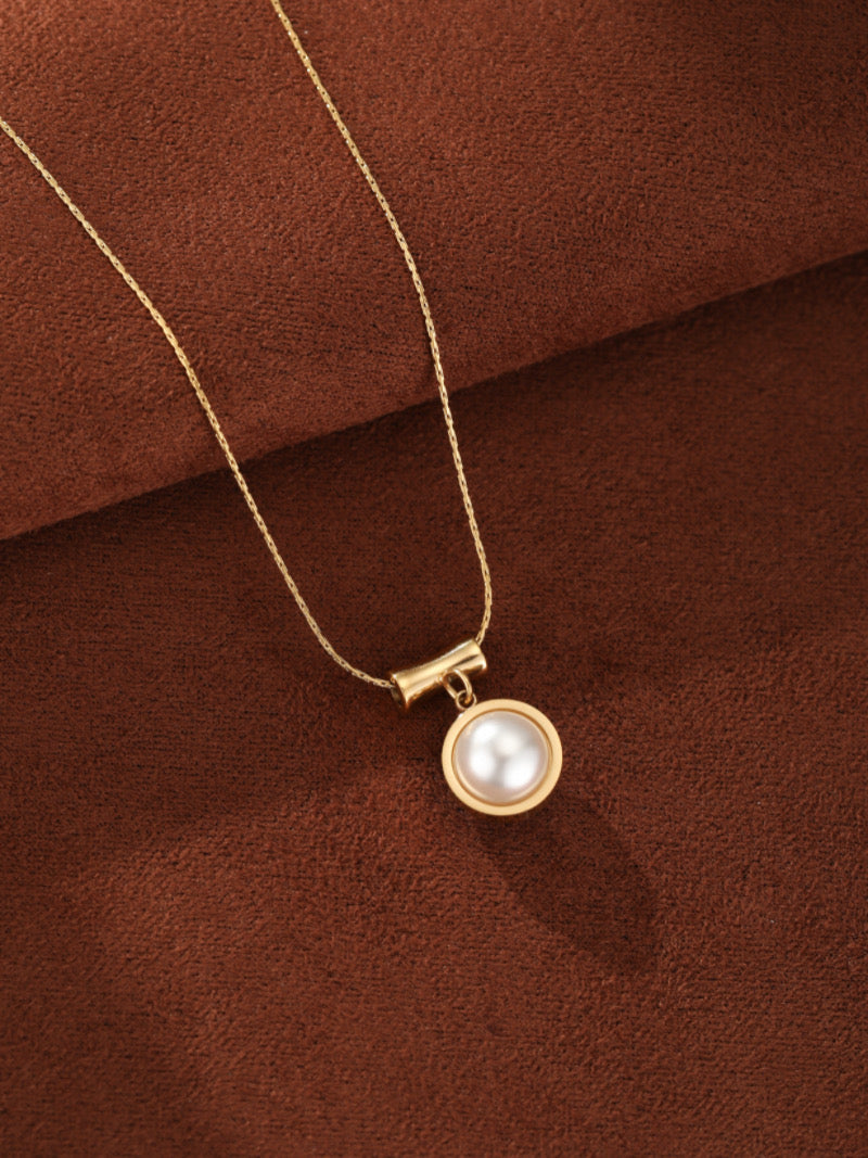 Glimpse - Freshwater Pearl Pendant Necklace with a single, lustrous 10mm Round White Freshwater Pearl set in a gold-toned bezel, suspended from a minimalist horizontal bar on a delicate gold chain.