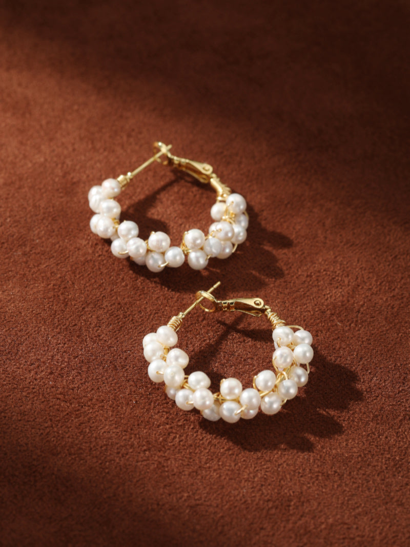 Grove Freshwater Pearl Hoop Drop Earrings featuring a cluster of small, luminous white seed pearls wrapped around a delicate gold hoop. @pearl