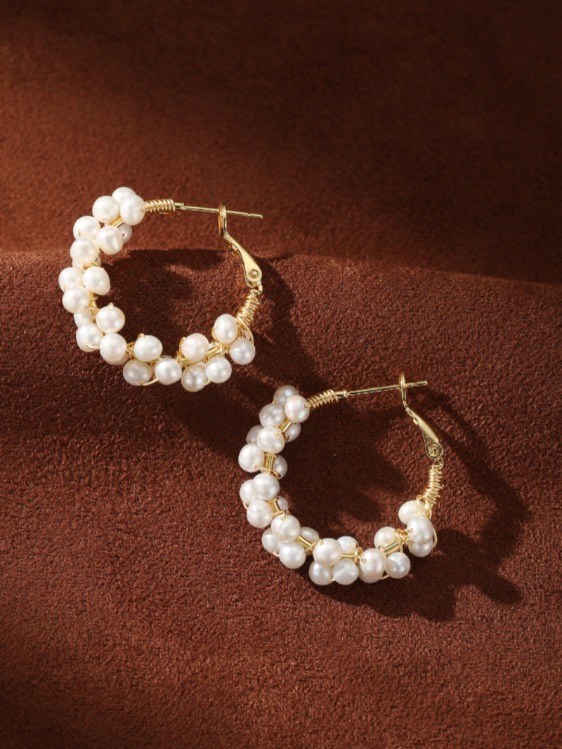 A pair of Grove Freshwater Pearl Hoop Drop Earrings featuring small white seed pearls clustered around a gold-toned hoop.@pearl