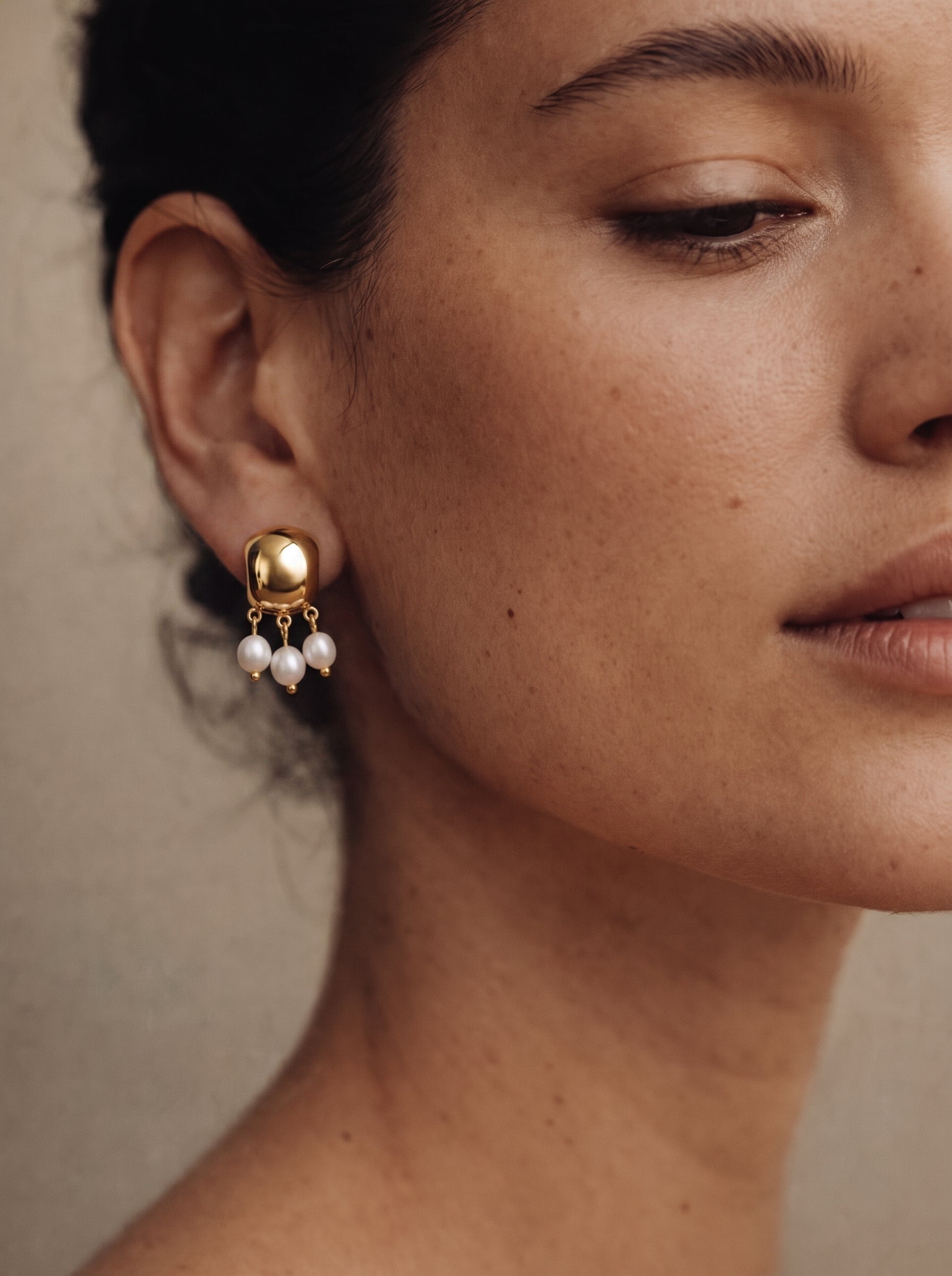 Harvest - Freshwater Pearl Drop Earrings featuring a gold square top with three dangling white seed pearls, worn by a model. @model