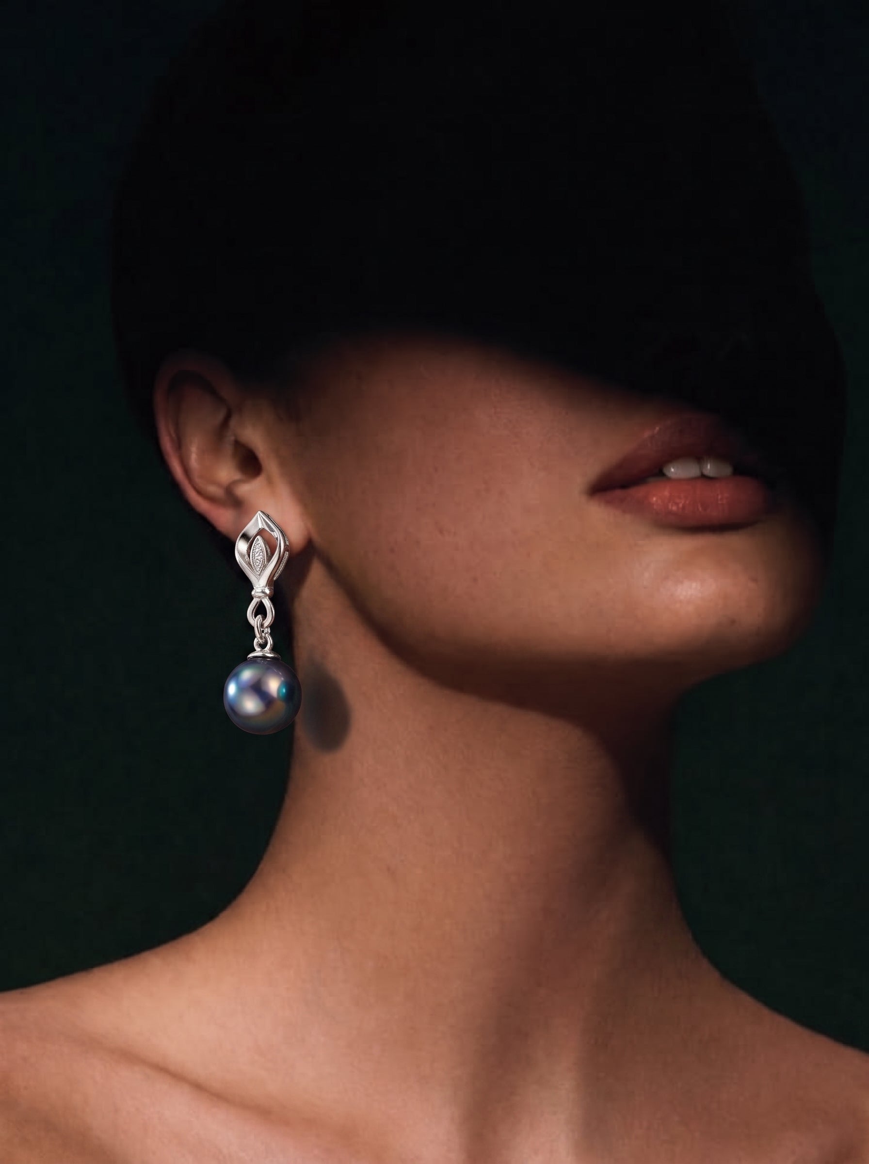 Ignis Tahitian Pearl Diamond Leaf Drop Earrings featuring a 10mm round Tahitian pearl suspended from a stylized leaf motif with pavé diamonds, worn by a model. @model