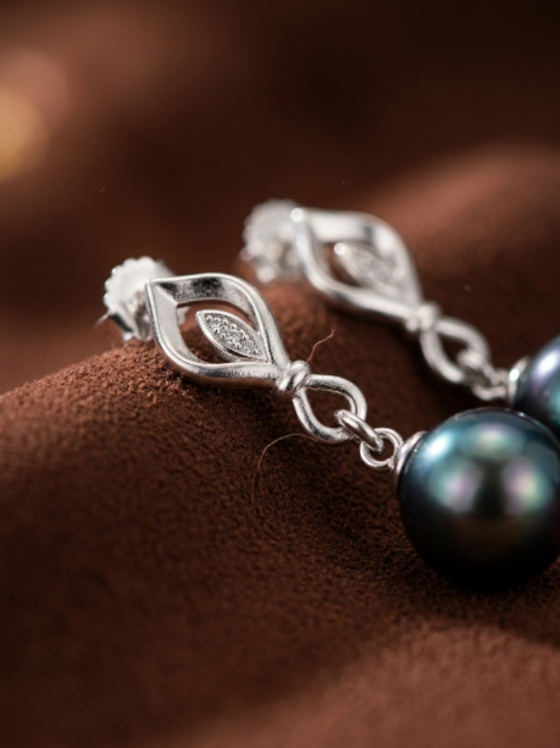 Ignis Tahitian Pearl Diamond Leaf Drop Earrings featuring a polished silver leaf design with pavé diamonds and lustrous 10mm black Tahitian pearls.