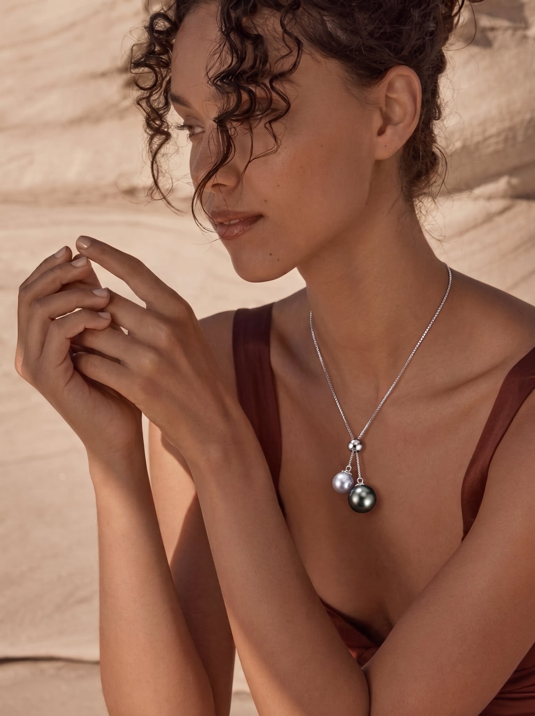 Model wearing a Lunar Flow adjustable Y-drop necklace featuring a Tahitian pearl and an Akoya pearl pendant, @lifestyle