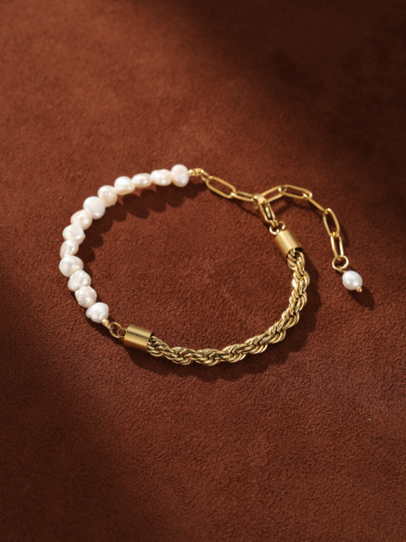 A gold-tone rope chain bracelet accented with a strand of irregular white freshwater pearls and a single pearl at the clasp.