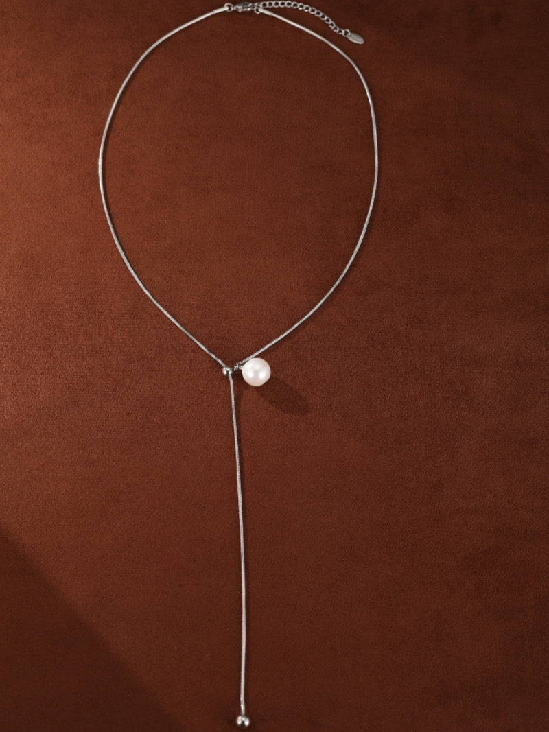Sheen - Freshwater Pearl Long Necklace with a single 8mm white pearl on a delicate silver chain with an adjustable slider and a drop chain accent.