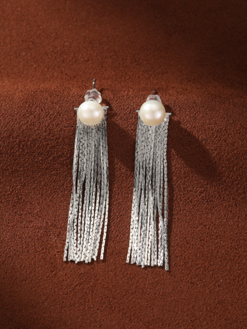 A pair of Shimmer Freshwater Pearl Fringe Dangle Earrings featuring a single baroque pearl stud with a cascade of silver-toned metallic fringe strands.