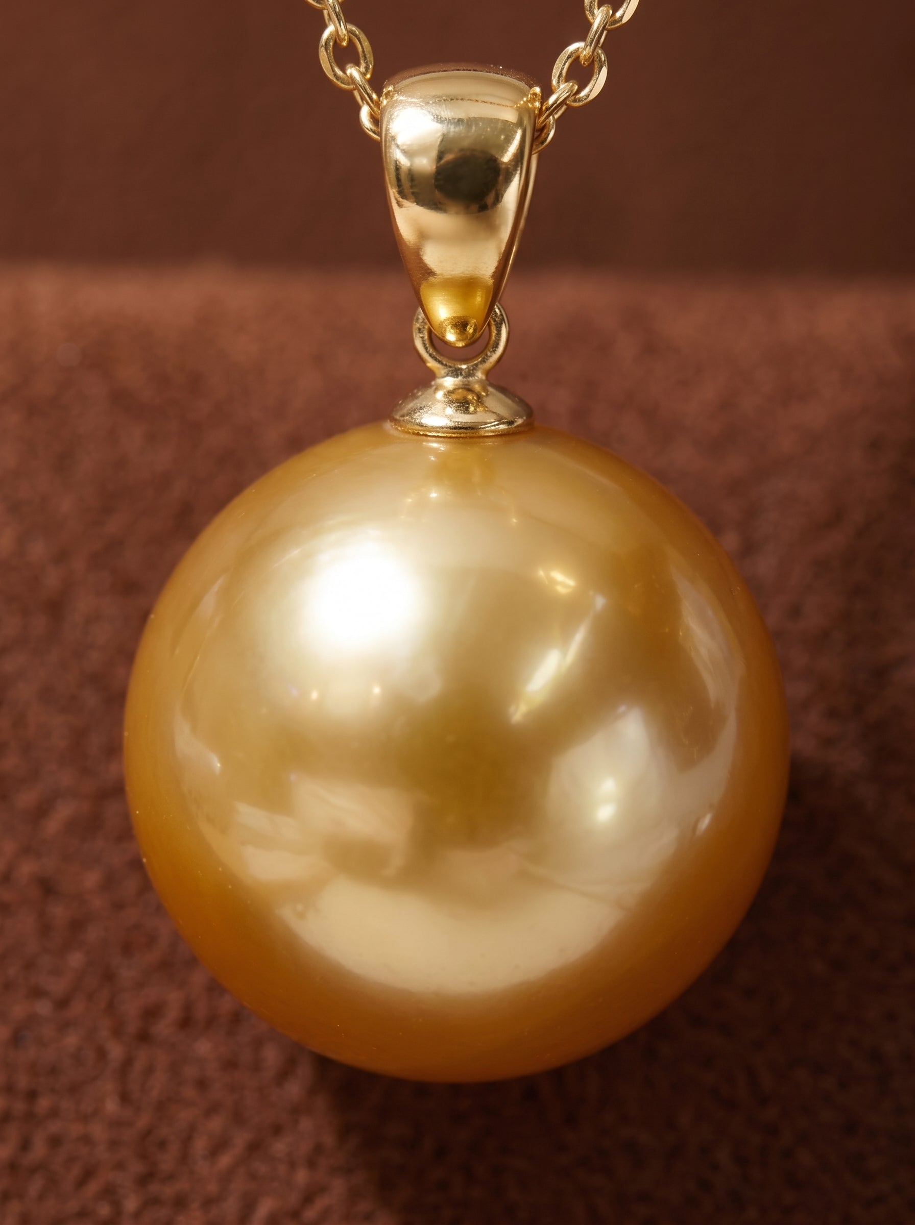 Solar Kiss - Freshwater Pearl Pendant Necklace with a large, round golden pearl suspended from a delicate gold-tone chain. @pearl