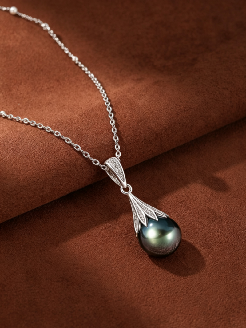 Vortex Tahitian Pearl Drop Necklace featuring a teardrop-shaped black Tahitian pearl suspended from a delicate silver chain and a pavé-set cap. @pearl