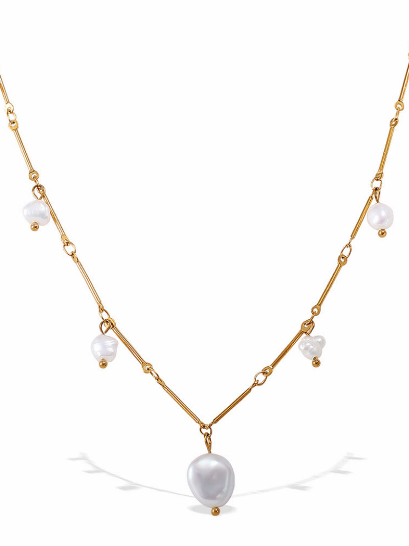 A delicate gold-tone chain necklace featuring small white freshwater pearls and a larger, irregular baroque pearl pendant. The necklace has an adjustable chain.