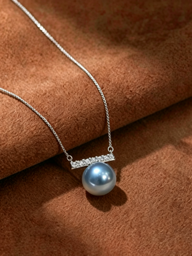 Azure - Akoya Pearl Bar Pendant Necklace featuring a single, lustrous 9mm round Akoya pearl with silver and blue hues, suspended from a horizontal bar accented with clear stones on a delicate silver chain.