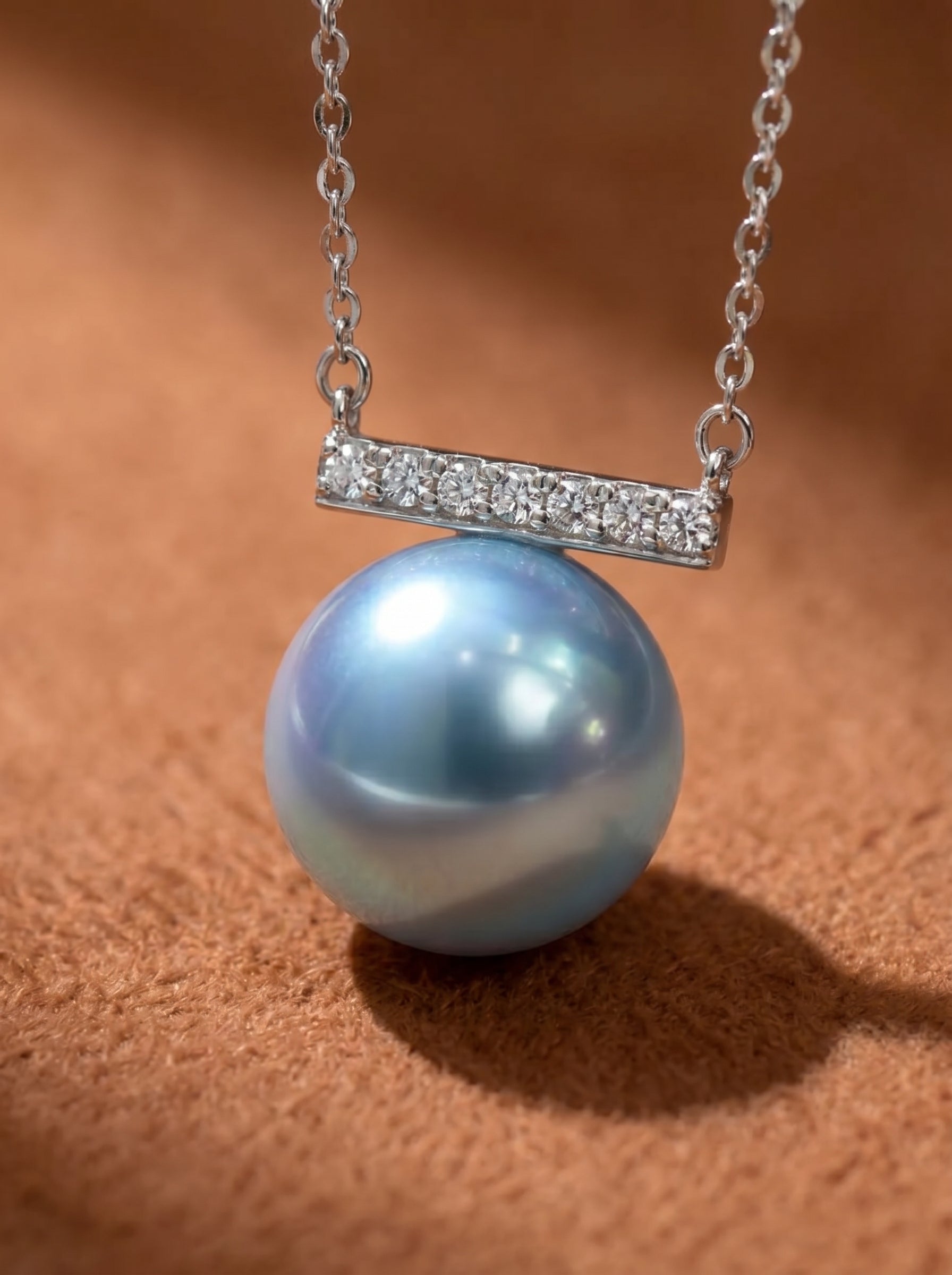 Azure - Akoya Pearl Bar Pendant Necklace featuring a lustrous 9mm round Akoya pearl with silver and blue hues, suspended beneath a delicate bar accented with clear stones. @pearl