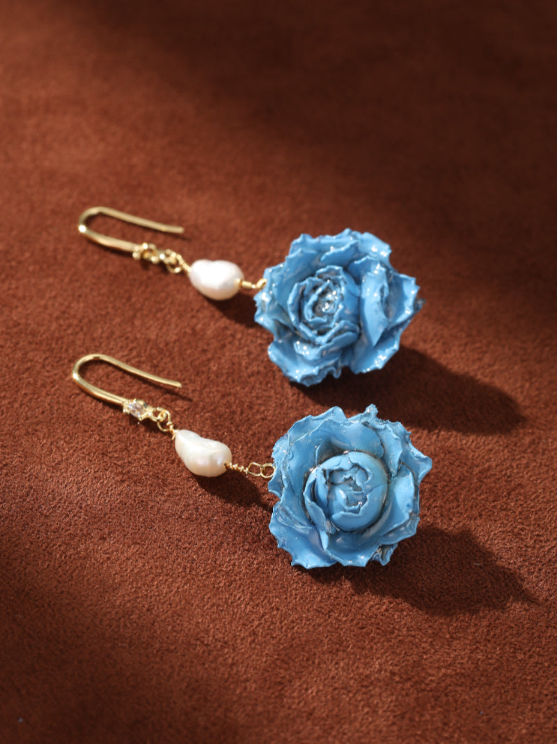 Celeste Reverie blue freshwater pearl flower dangle earrings with textured rose motifs and baroque pearls on gold hooks.