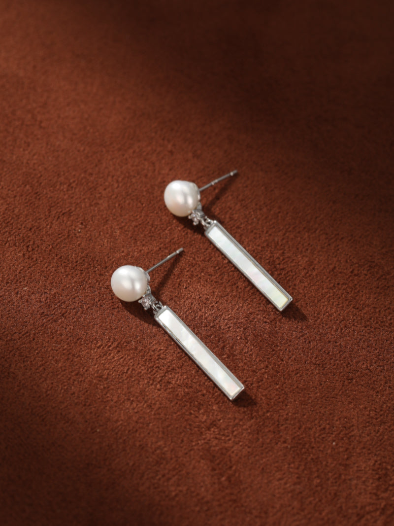 Column - Freshwater Pearl Stud Drop Earrings featuring a 6 mm white button-shaped freshwater pearl stud with a small sparkling accent, leading to a sleek, rectangular drop element with a subtle iridescence.