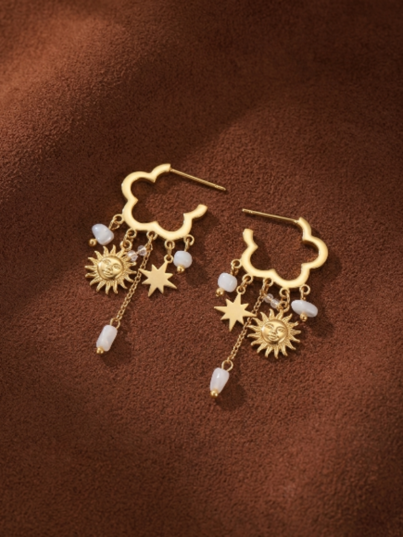 Gold cloud-shaped dangle earrings featuring a sun charm, a star charm, and small white freshwater pearls.