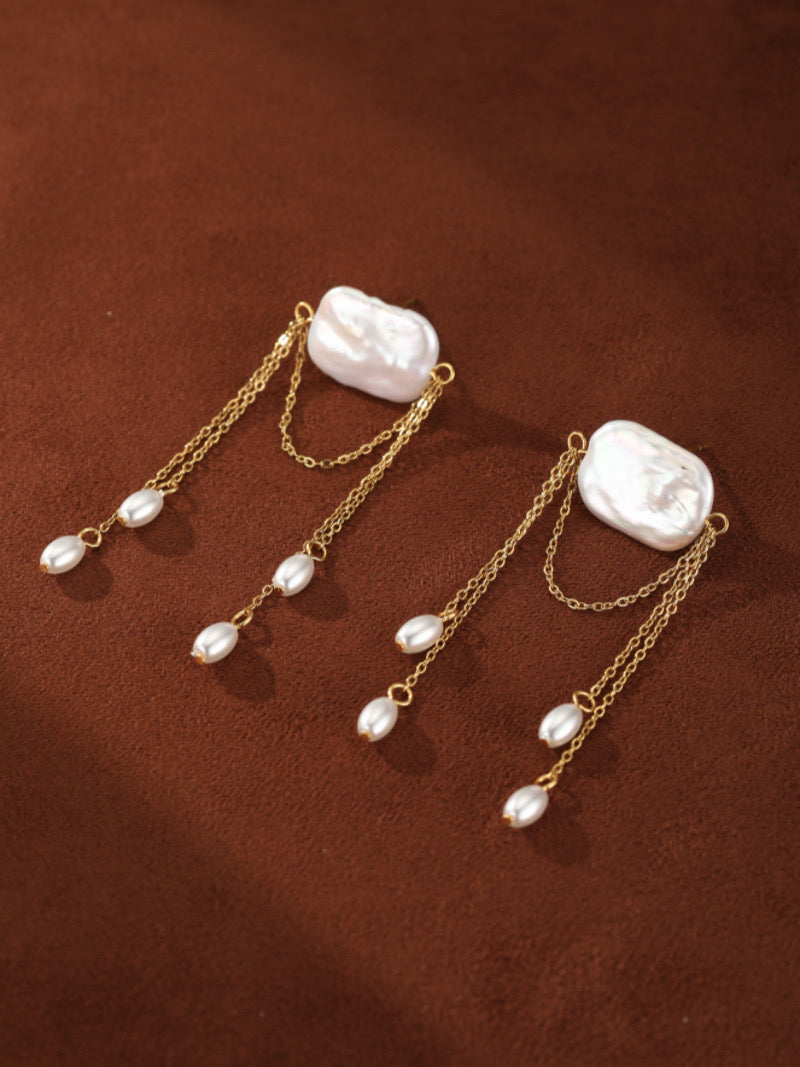 Driftfall Freshwater Pearl Fringe Drop Earrings featuring a large baroque pearl with delicate gold chains adorned with smaller white pearls.