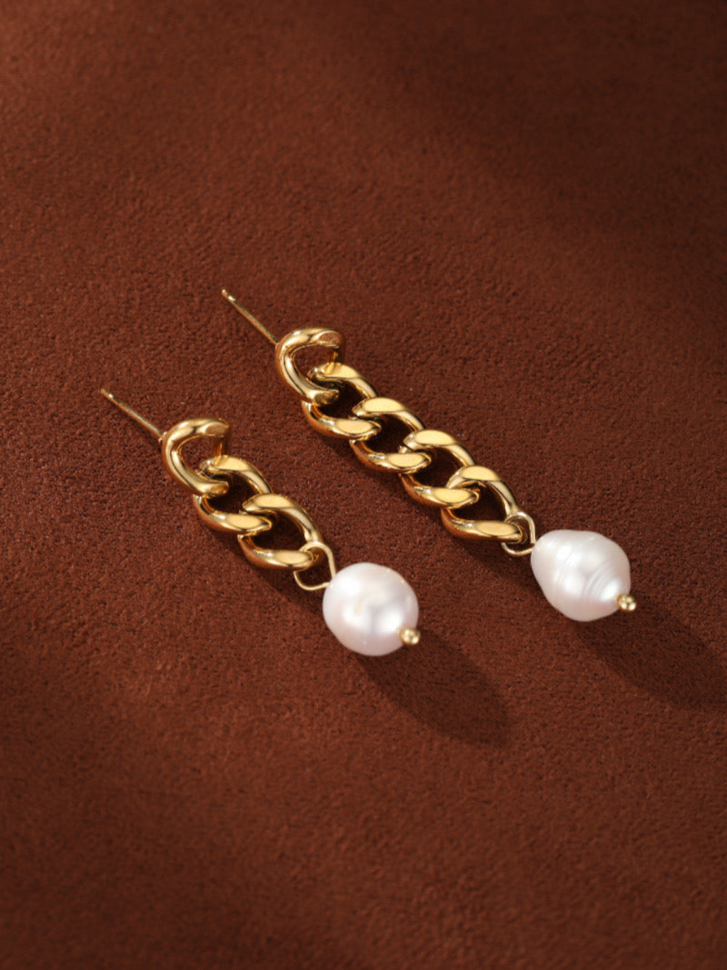 Gold-toned chain dangle earrings featuring a lustrous white freshwater pearl at the end of each chain.
