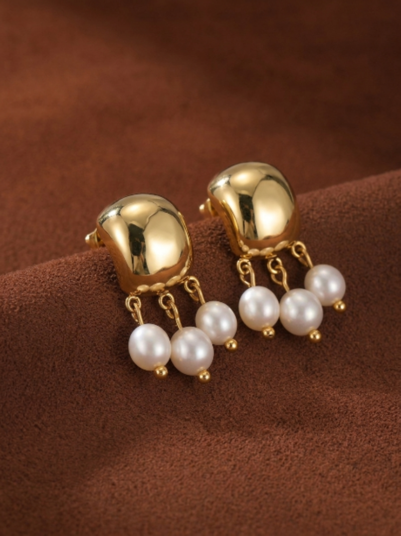 Harvest Freshwater Pearl Drop Earrings featuring a hammered gold top and three delicate white freshwater seed pearls dangling from each earring.