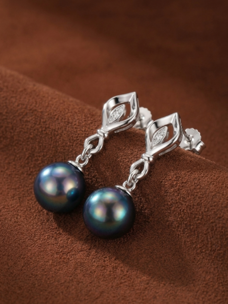 Ignis Tahitian pearl and diamond leaf drop earrings in sterling silver with iridescent black pearls.