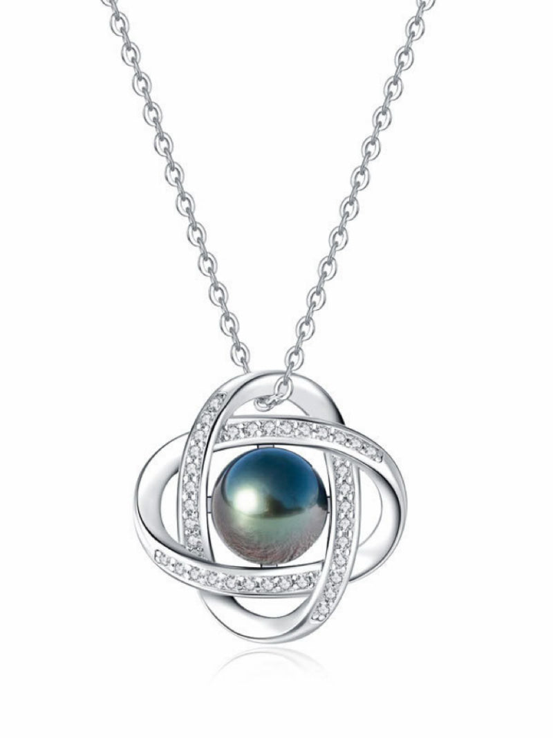 Interstellar necklace featuring a lustrous 10 mm round black Tahitian pearl set in a contemporary sterling silver quatrefoil design accented with sparkling cubic zirconia, suspended from a delicate chain. @pearl