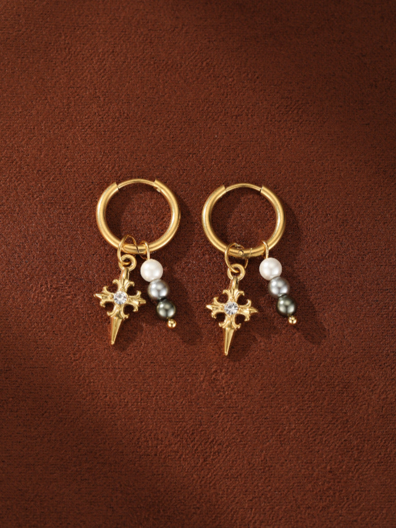 Pair of gold-tone hoop earrings with dangling cross charms adorned with a diamond and a cluster of white and grey freshwater pearls.