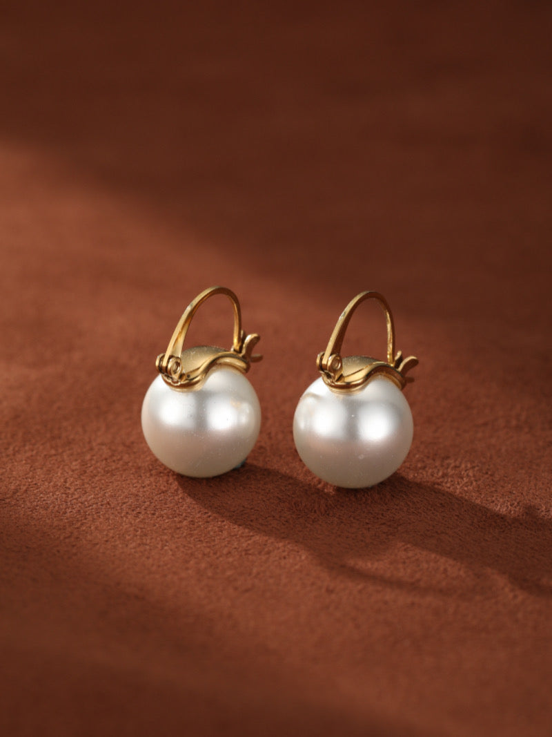 Lode - Gold-toned hoop drop earrings featuring large, round white freshwater pearls.