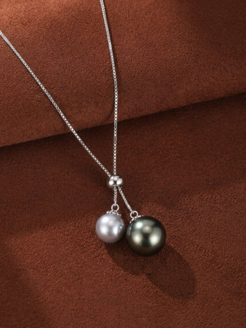 Adjustable Y-drop necklace featuring a 10mm Tahitian pearl and an 8mm Akoya pearl on a silver chain.