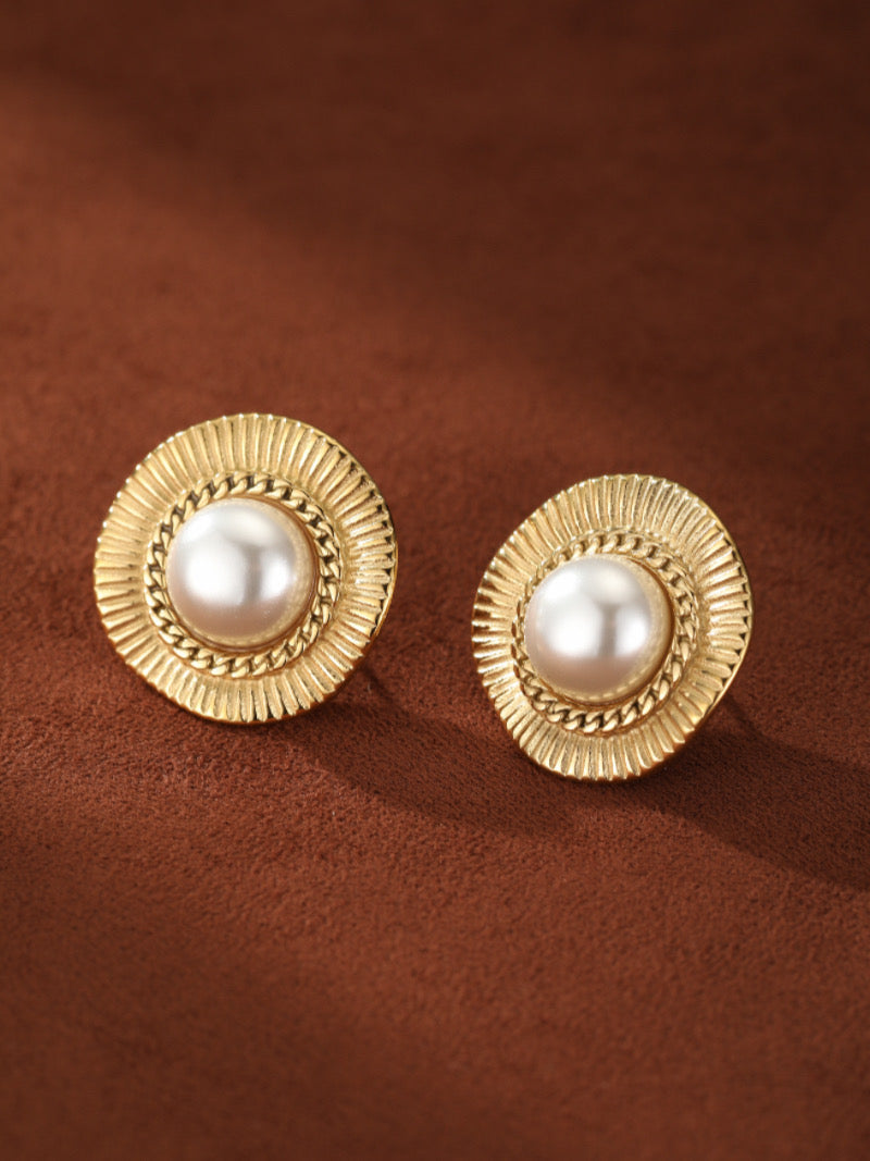 Pair of Meridian Shine gold-toned stud earrings, each featuring a lustrous white freshwater pearl surrounded by a textured sunburst frame and a delicate chain-link detail.