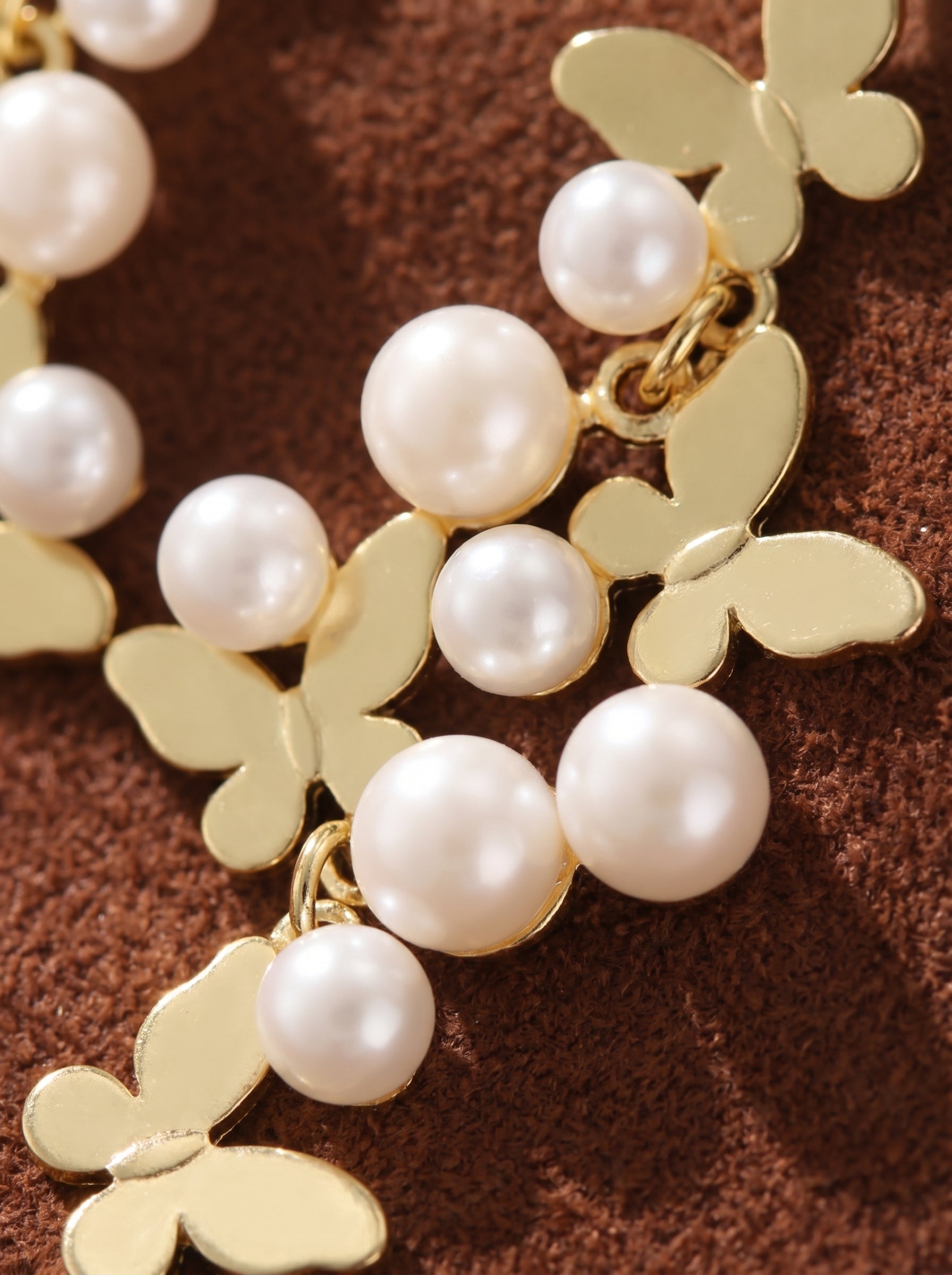 Metamorph Freshwater Pearl Butterfly Dangle Earrings featuring gold butterfly charms and clusters of white button pearls.@pearl