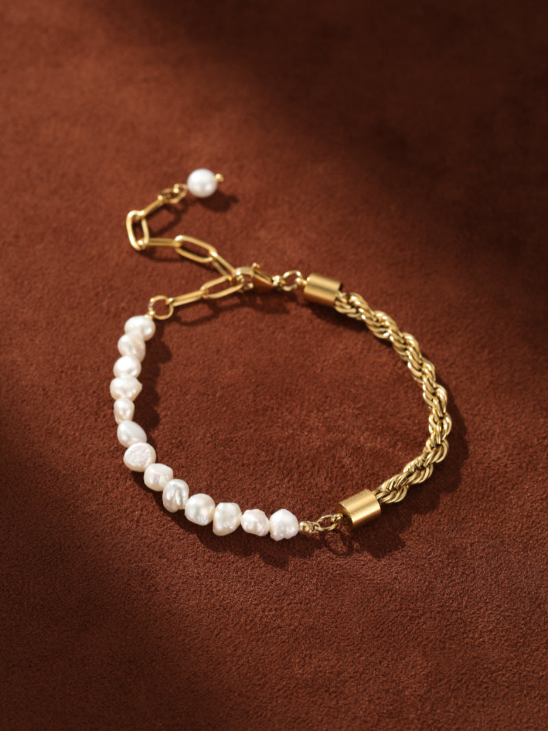 Gold-tone rope chain bracelet with a section of irregular white freshwater pearls and a pearl accent on the extender chain.