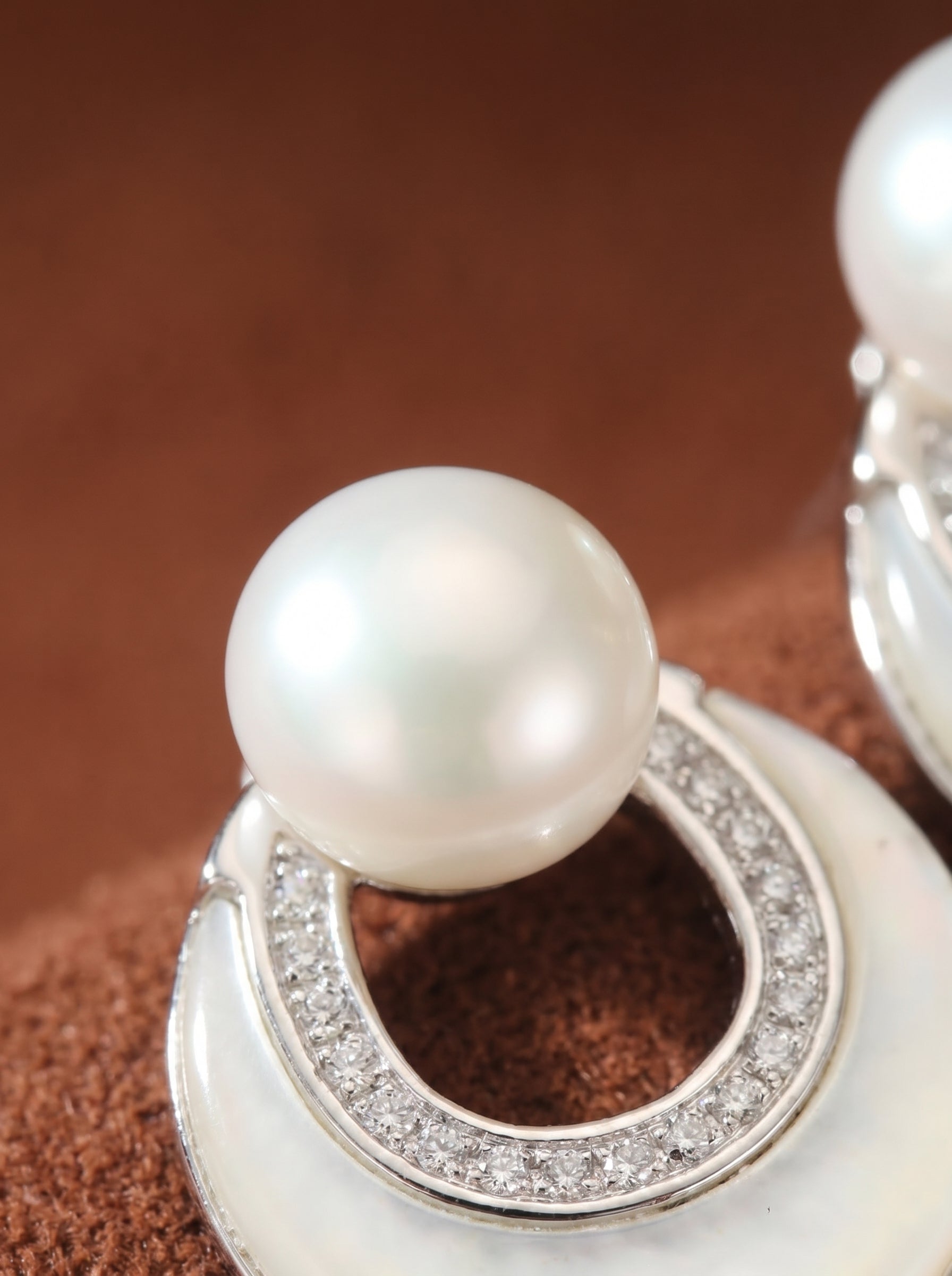 Close-up of Nimbus Freshwater Pearl Moon Hoop Drop Earrings featuring a luminous white button pearl set above a double crescent design with pavé diamonds and polished silver tone, @pearl