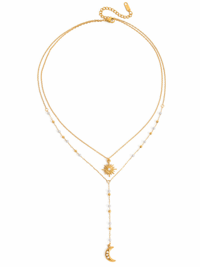 Nova - Gold-toned layered necklace with freshwater pearls, featuring a sun pendant on the top chain and a crescent moon charm on the longer drop chain.