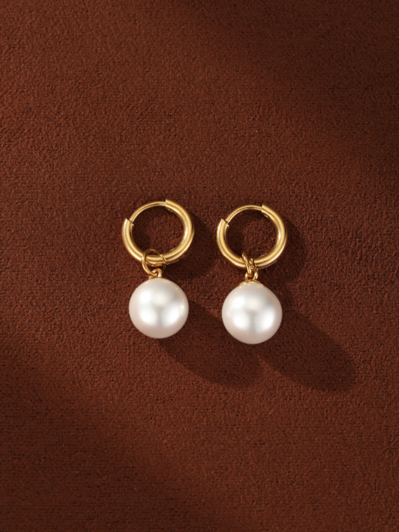 Paire de boucles d'oreilles goutte créoles ton or, chacune présentant une lustrée perle blanche d'eau douce de 8 mm suspendue sous la créole.