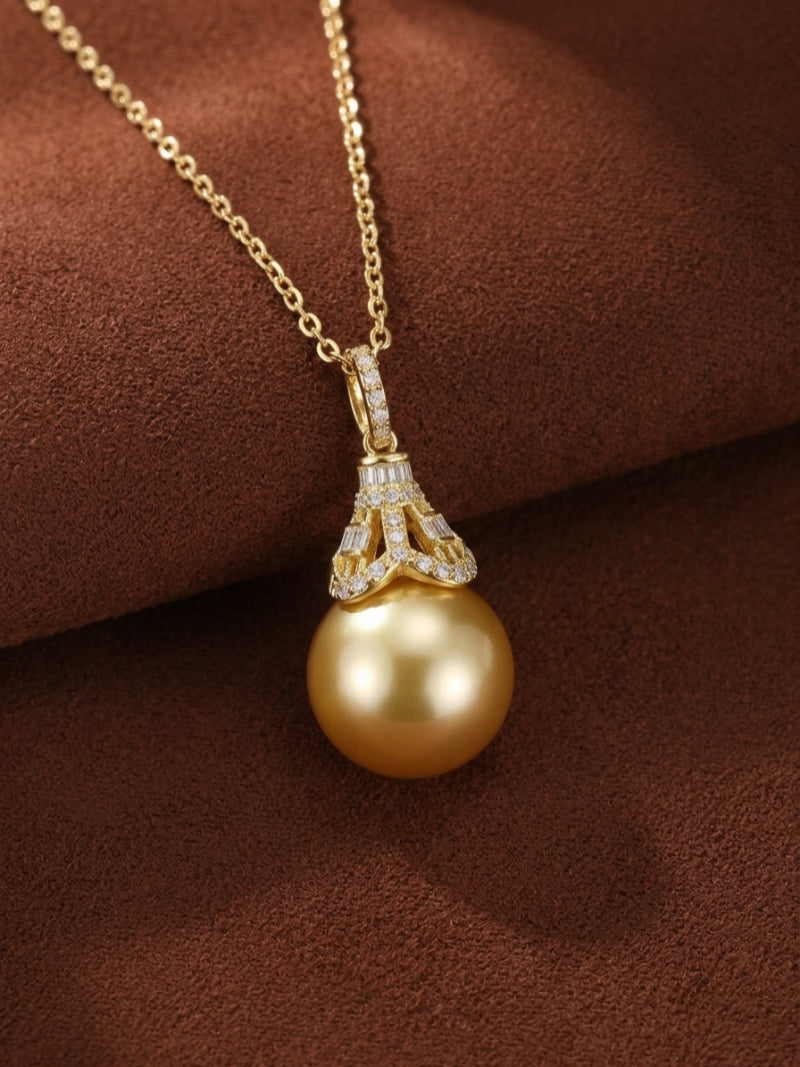 Regal Glow - A 14mm round golden South Sea pearl pendant necklace with a diamond-encrusted cap featuring round and baguette-cut diamonds, suspended from a delicate gold chain.