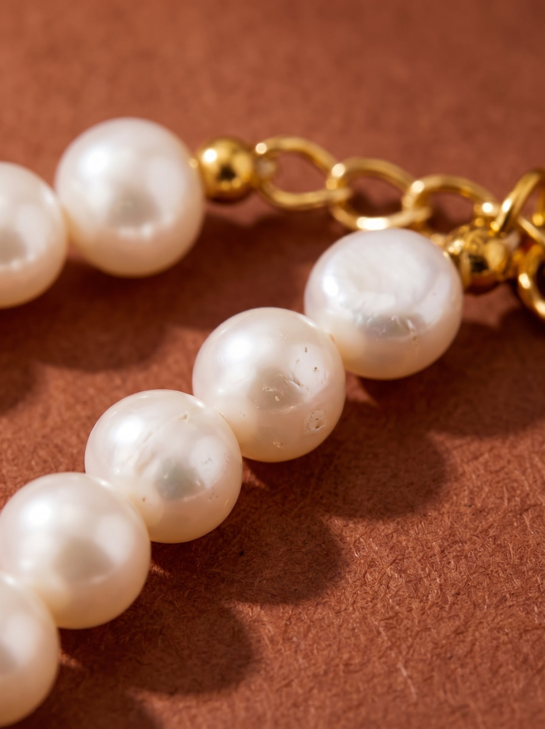 Close-up of a Serene Strand choker necklace featuring lustrous 6mm freshwater button pearls and a gold-toned clasp.