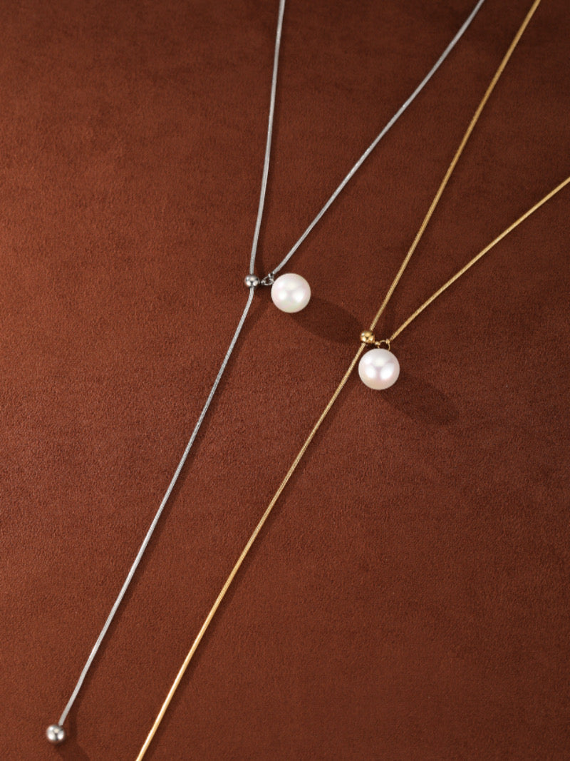 Two Sheen freshwater pearl long necklaces, one in silver tone and one in gold tone, each featuring a single 8mm round white pearl suspended on a delicate chain with an adjustable slider design.