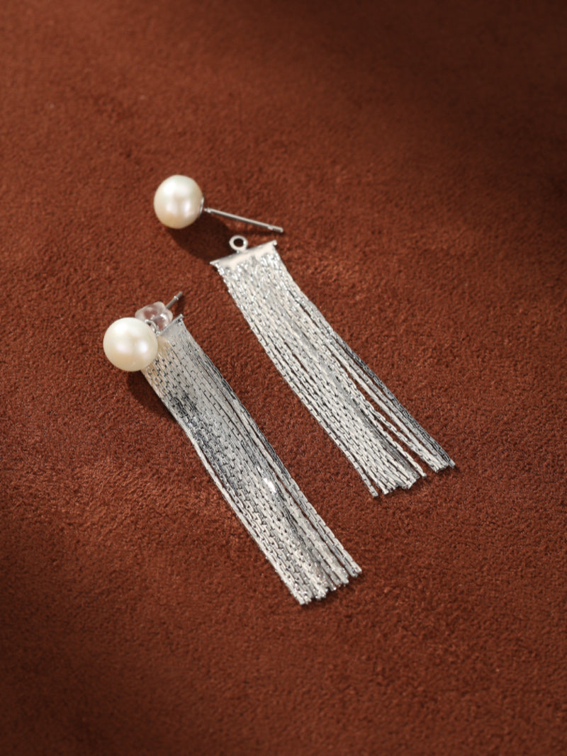 Shimmer - Freshwater Pearl Fringe Dangle Earrings featuring a single white baroque freshwater pearl stud and a cascade of silver-toned metallic fringe strands. @pearl