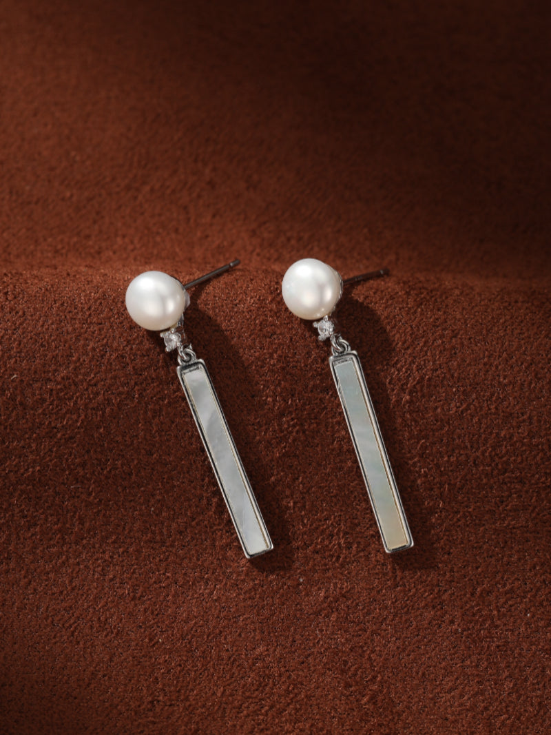 Vector Freshwater Pearl Bar Drop Earrings featuring a white button-shaped pearl stud, a small cluster of sparkling stones, and a rectangular bar drop with subtle iridescence.@pearl