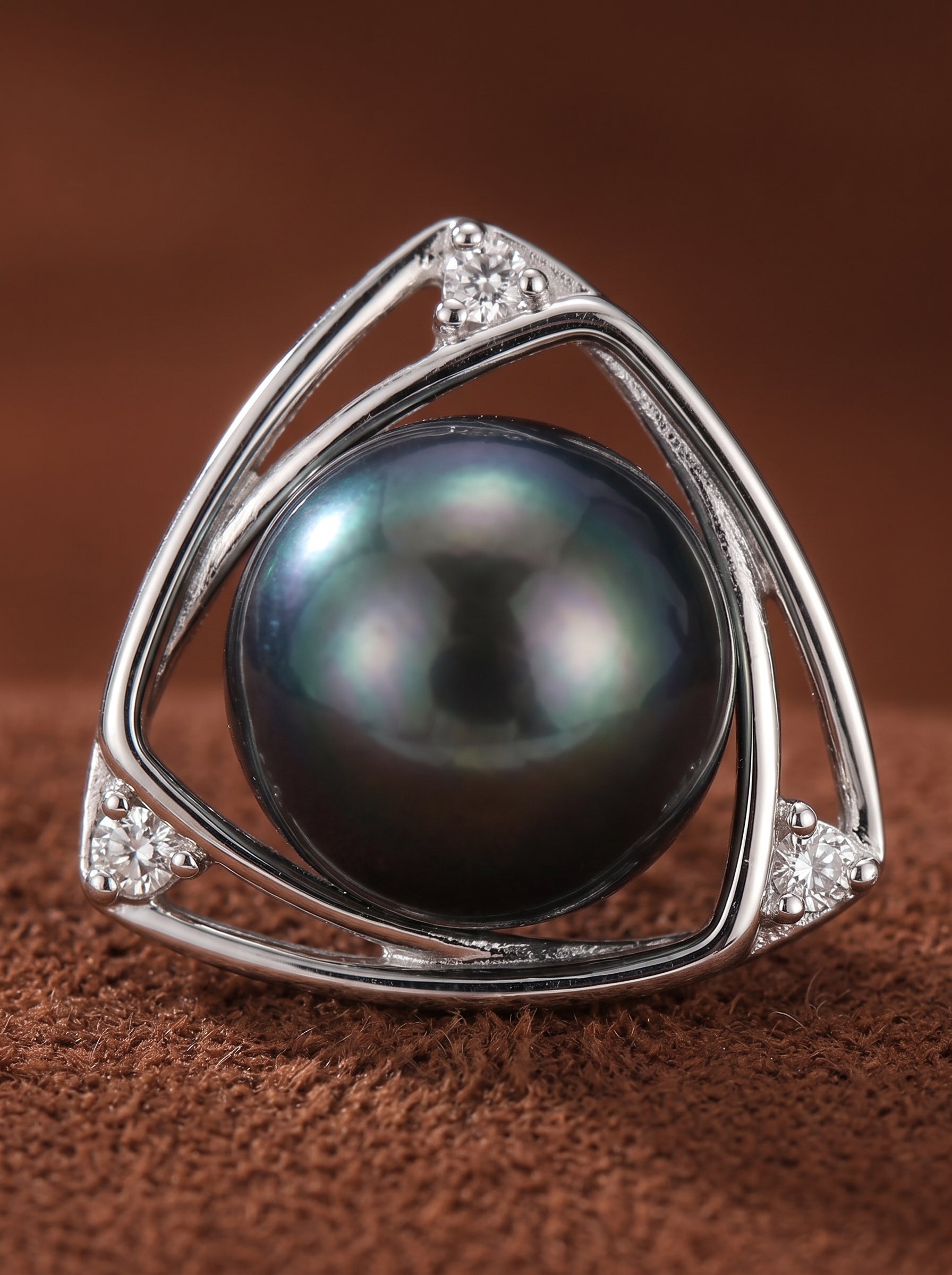 Vertex - Tahitian Pearl Triangle Stud Earrings featuring a 11mm black Tahitian pearl set in a silver triangular frame with pavé stones. @pearl