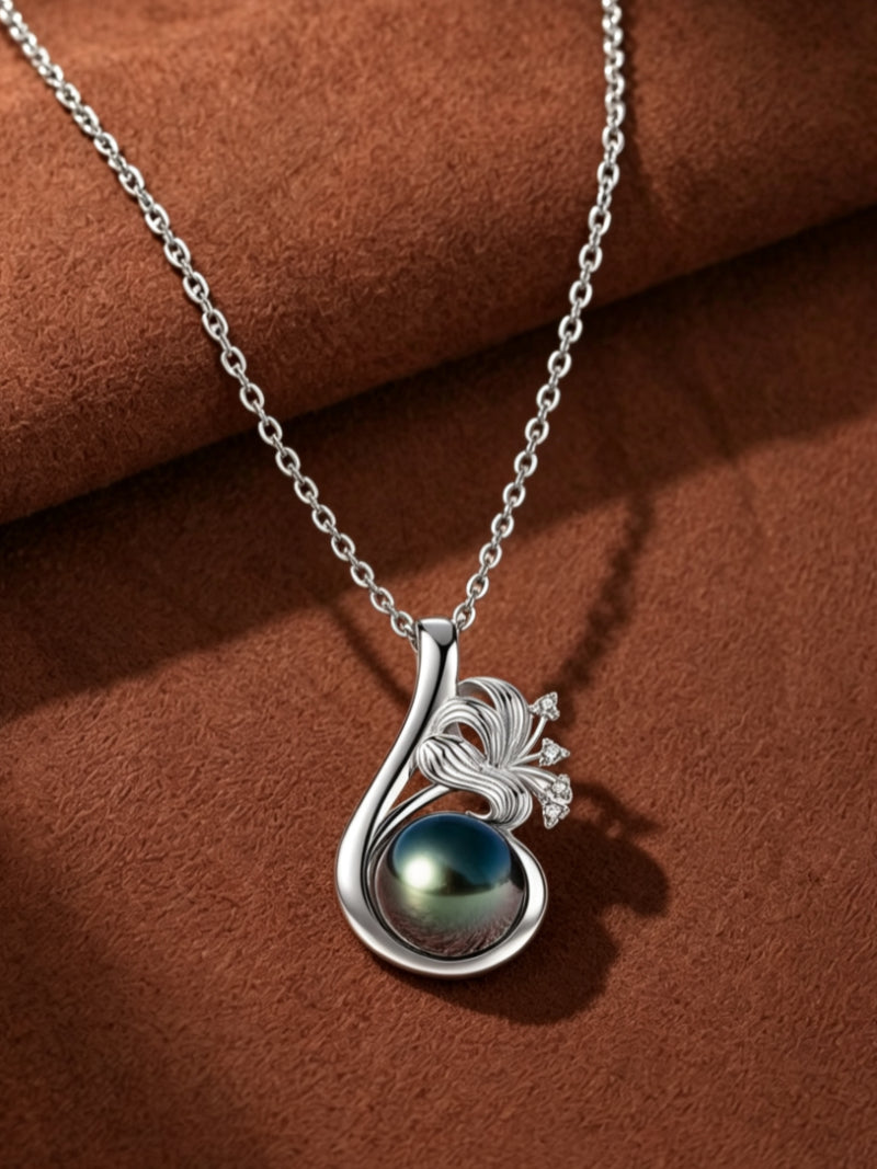 Vivid Bloom necklace featuring a lustrous black Tahitian pearl cradled within a silver flower pendant with sparkling accents.